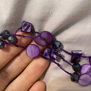Purple bead/shell necklace.